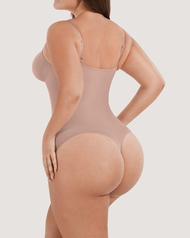 Woman wearing the BZEZ Smoothing Sculpt Bodysuit Thong in Bare, back view