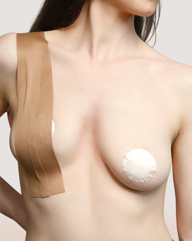 Woman wearing BZEZ Breast Tape to lift her bust, with a nipple cover
